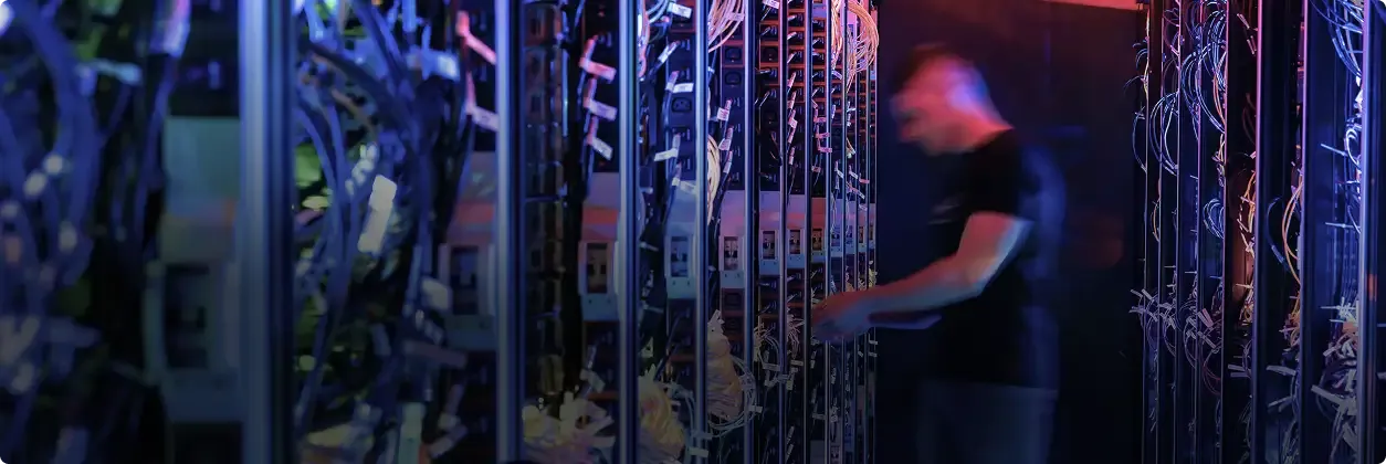 Technician working in a secure data center, monitoring servers and critical infrastructure