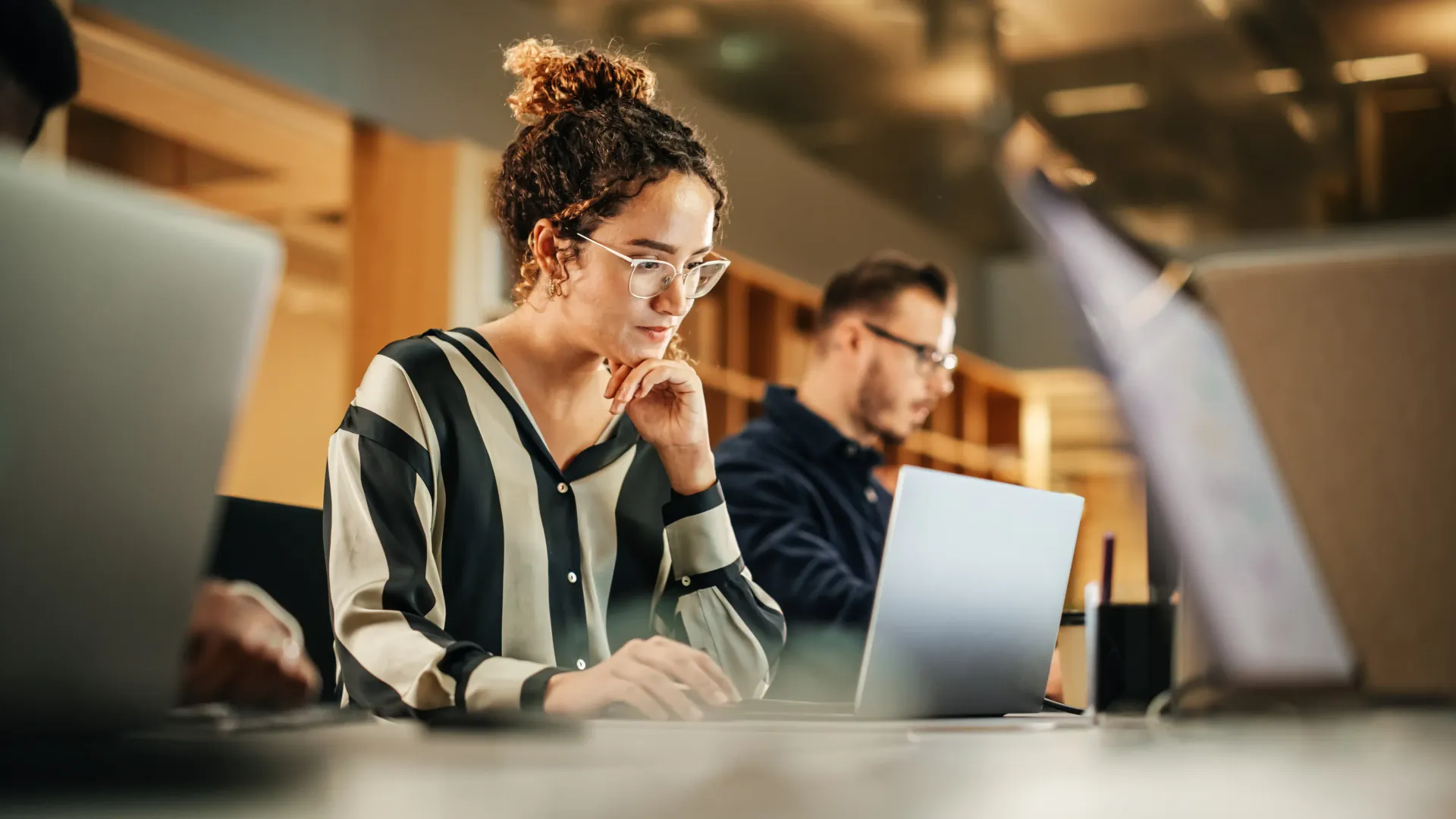 Image of two people looking at a computer while talking